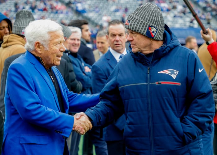 New England Patriots owner Robert Kraft (left) shares a pregame handshake with coach Bill Belichick.